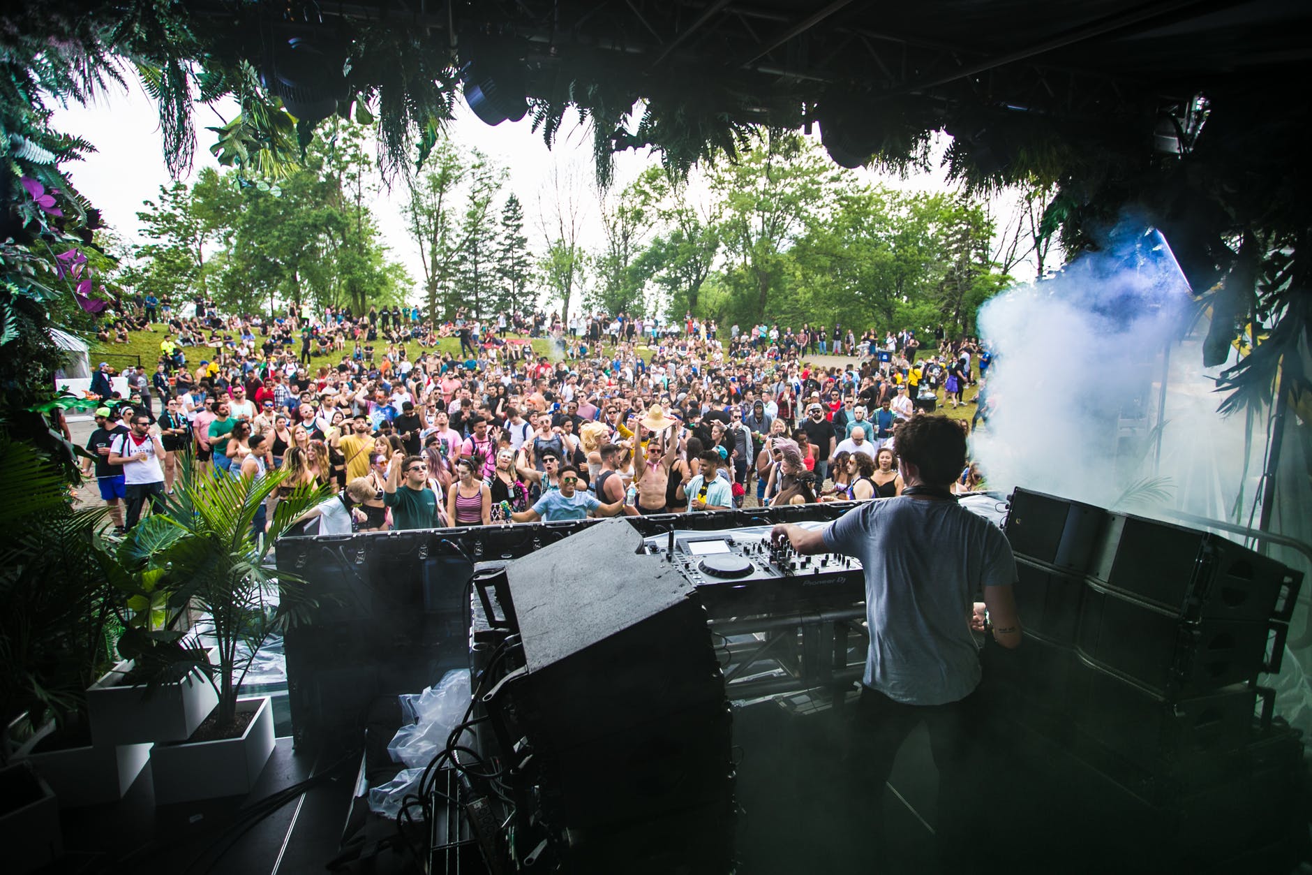 dj controlling disc in front of crowd